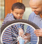 Father and son fixing a bike.